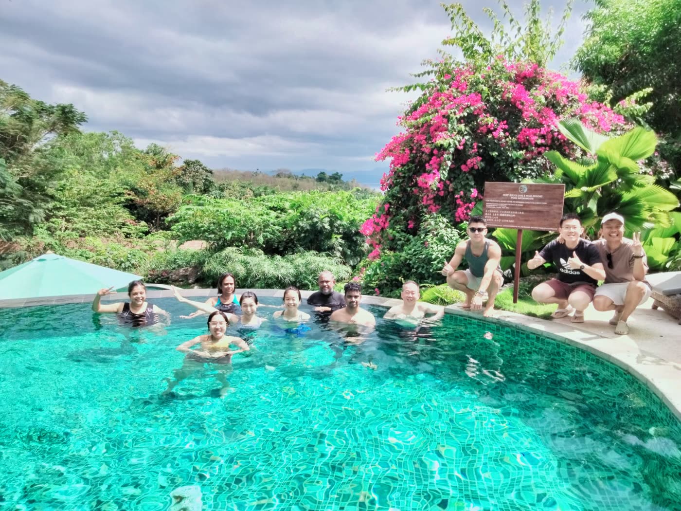 Mentors relaxing in an infinity pool surrounded by jungle
